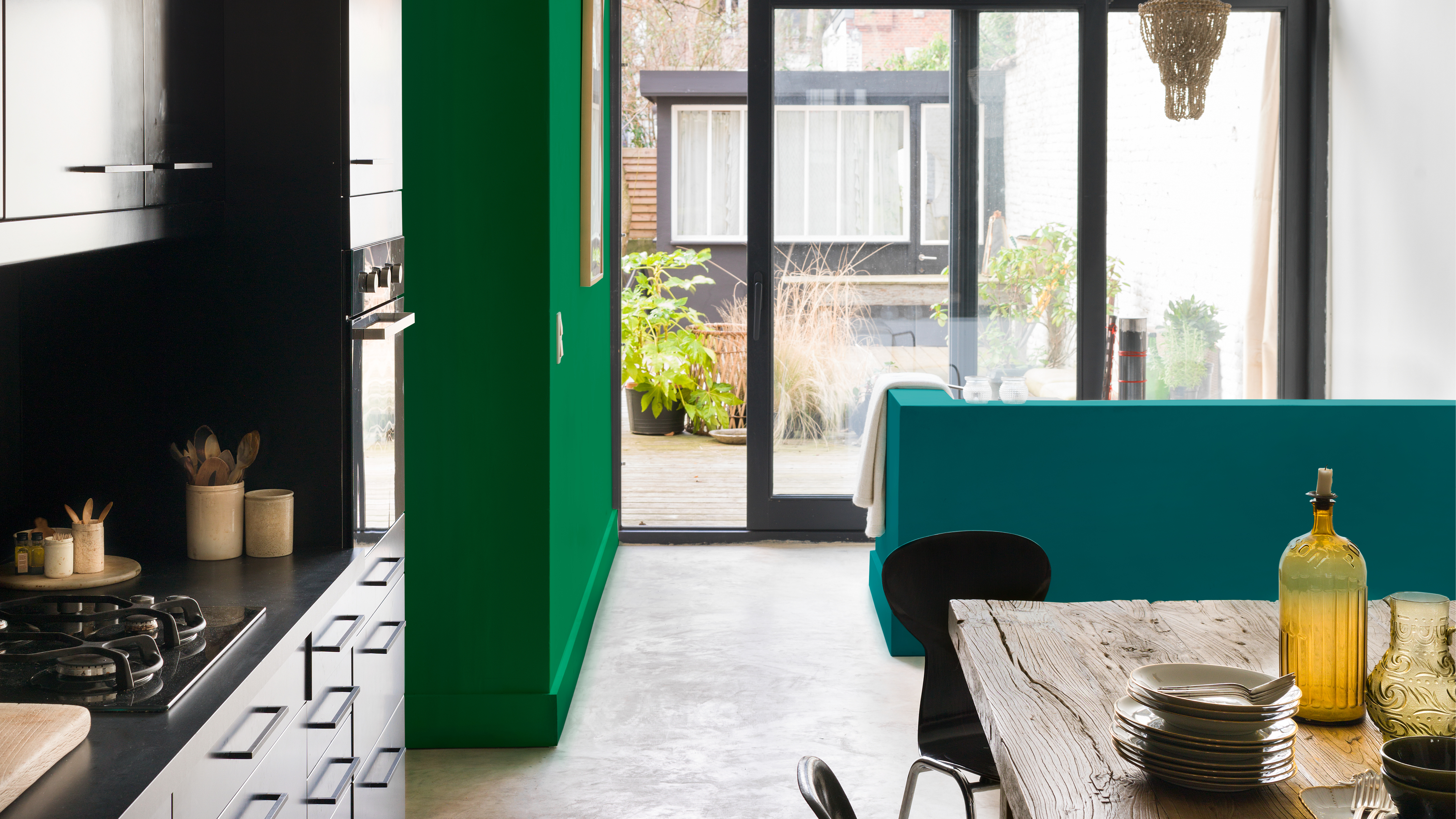Une cuisine ouverte avec un mur vert Le moyen le plus simple de créer une pièce ouverte harmonieuse consiste à choisir une ou deux couleurs et à les utiliser dans différentes nuances.